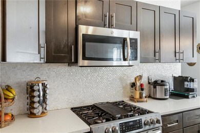 Kitchen with decorative backsplash, light countert