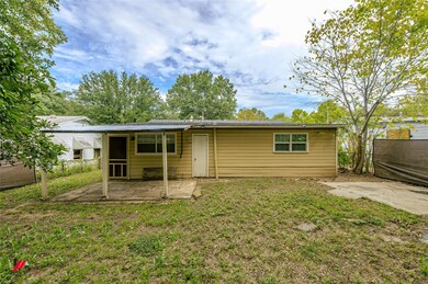 Back of property featuring a lawn and a patio area