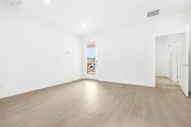 Spare room featuring light wood finished floors an