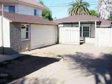 2 car garage and front of rear house with gated ya