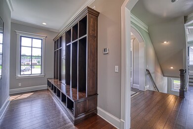 Mud room off of garage with custom lockers