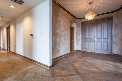Grand double doored Foyer has an adjacent half bat