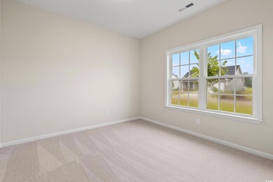 Spare room featuring light colored carpet and baseboards