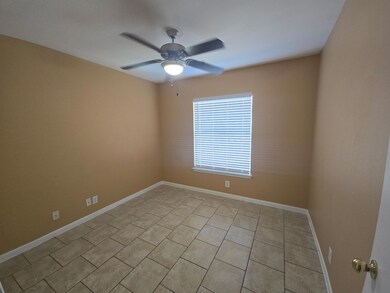 Spare room with light tile patterned flooring and a ceiling fan