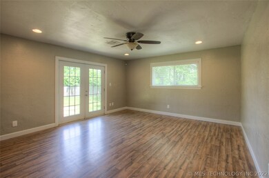 Living room with can lighting & french doors to ba