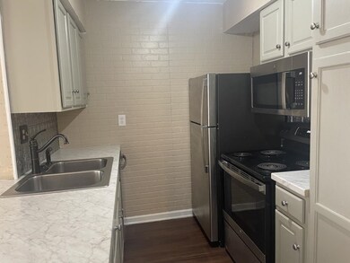 Kitchen featuring black electric range oven, sink,