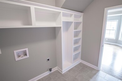 Ceramic tile utility room/mud room with built ins. Same floor plan in different color palette.