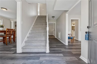 Stairway featuring wood finished floors and basebo