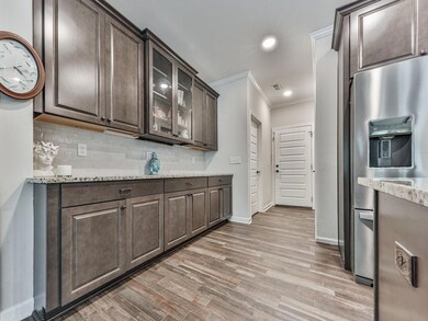 Kitchen with stainless steel refrigerator with ice