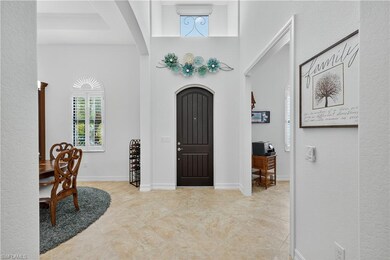 Foyer Entry with Soaring Ceiling Heights and Accent Window with Electric Shade