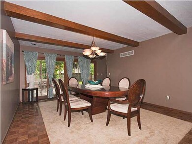 Beamed Formal Dining Room Opens onto the oversized