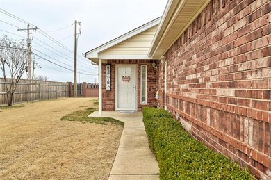 Entrance to property featuring a yard, brick sidin