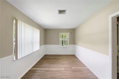 Unfurnished room featuring wainscoting and wood finished floors