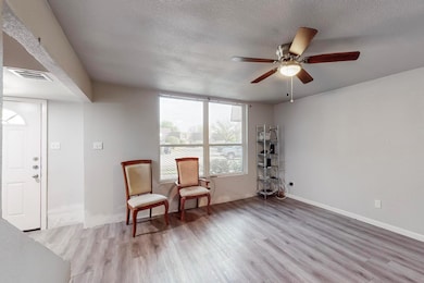 Sitting room featuring baseboards, a textured ceil