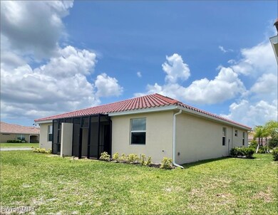 Back of property featuring stucco siding, a lawn,