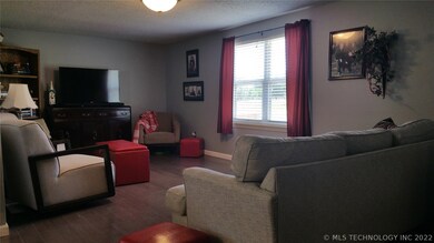 Inviting living room with hand scraped hard wood f