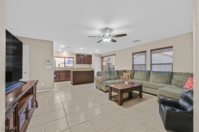 Living area with light tile patterned floors, visi