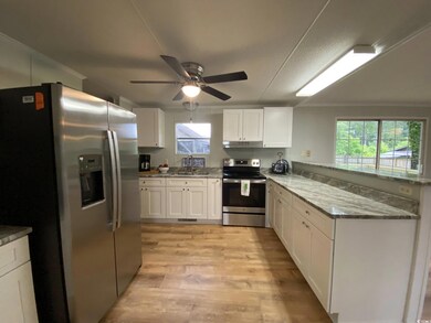 Kitchen featuring stainless steel appliances, a si