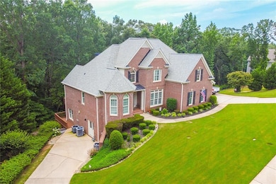 Traditional home with brick siding, driveway, and a front lawn