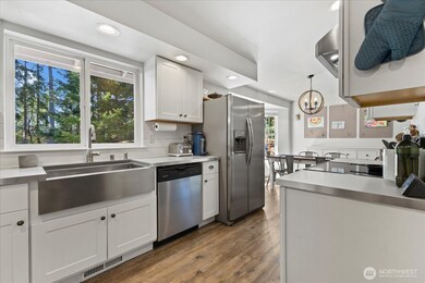 Kitchen w/ Stainless Steel appliances including a large farmhouse sink.