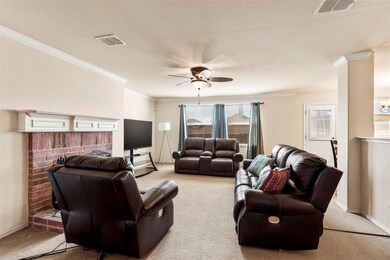 Carpeted living room with ceiling fan and decorati
