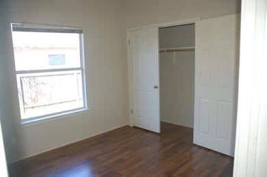 Unfurnished bedroom with dark wood-type flooring 