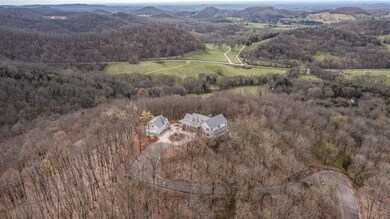 Perfectly situated on the knob of a hill overlooking the hollows and valleys of the surrounding landscape, the home is surrounded by nature.