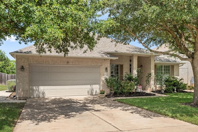 Ranch-style home with a shingled roof, driveway, and brick siding
