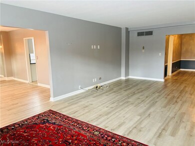 Living room featuring light wood type finished floors and baseboards