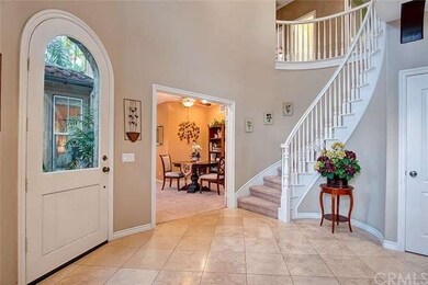 Formal foyer entry w/Travertine floor, spiral stai
