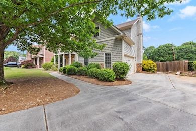 View of property exterior with stone siding, drive