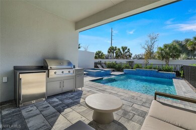 View of swimming pool featuring grilling area, a p