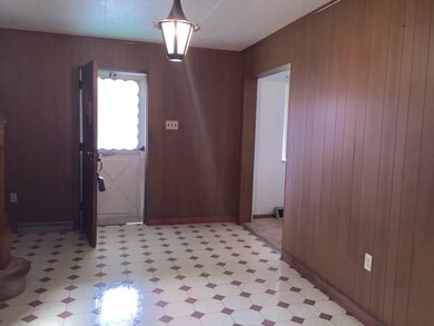 Front door that leads to the entry hallway with ce