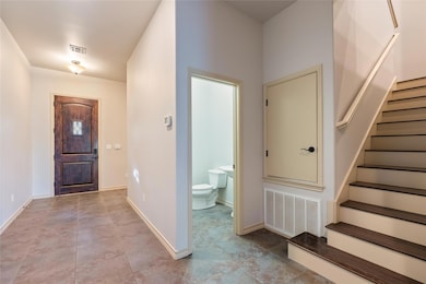 Foyer with stairway and light tile patterned floors