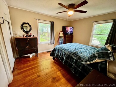 Spacious primary suite with beautiful hardwoods