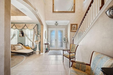 Custom double glass doors adorn the entrance of this elegant home.