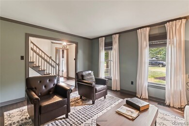 Sitting room featuring light parquet floors and cr