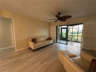 Living room with light wood-type flooring and ceil