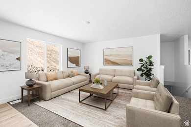 Living area featuring wood finished floors and a textured ceiling