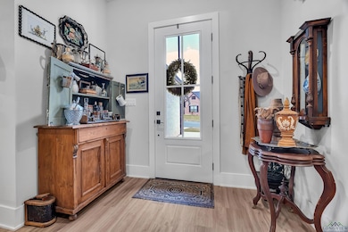 Entryway featuring light wood-style flooring and a dry bar