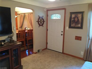 Living room flows into dining area with newer laminate floor.