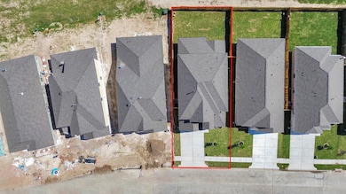An aerial view of a spacious subdivision lot, high