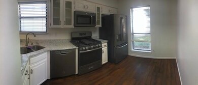 Kitchen featuring white cabinets, appliances with 
