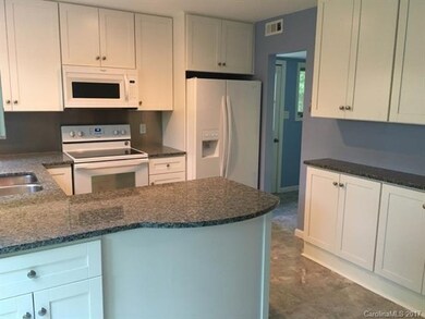 Counter bump out for bar seating. Mudroom from bac