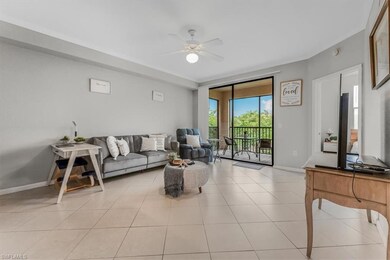 Living area with ceiling fan and light tile patterned flooring