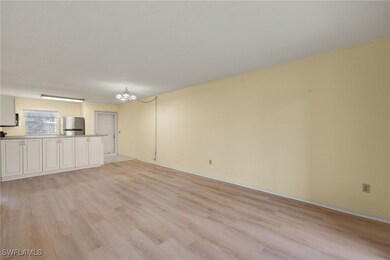 Unfurnished living room with a chandelier and ligh
