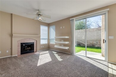 Family room has ceiling fan and gas fireplace and