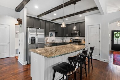 Newly refinished cabinets are framed by a classic tile backsplash. There's also a pantry for added storage!