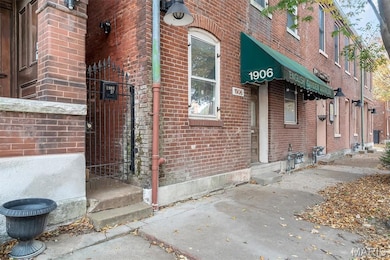 Entrance to property featuring brick siding