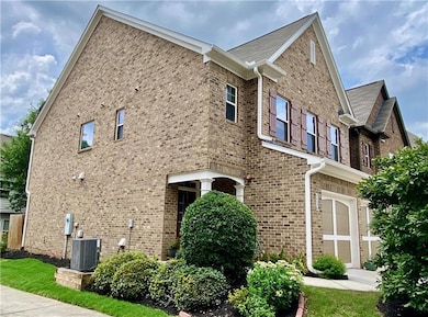 END UNIT. View of home's exterior with brick.